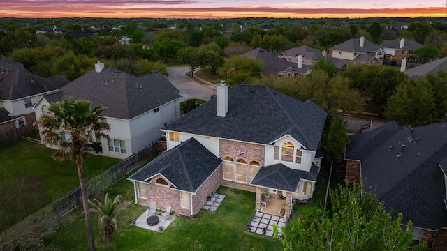 aerial view at dusk featuring a residential view