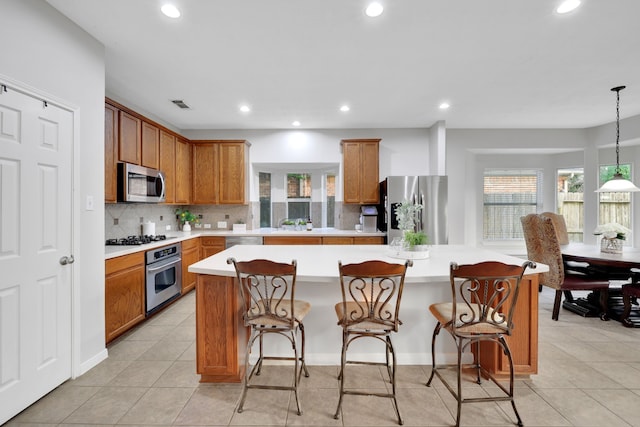kitchen featuring light countertops, tasteful backsplash, appliances with stainless steel finishes, visible vents, and recessed lighting