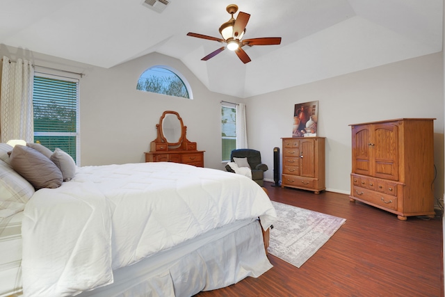 bedroom with dark wood-type flooring, multiple windows, lofted ceiling, and visible vents