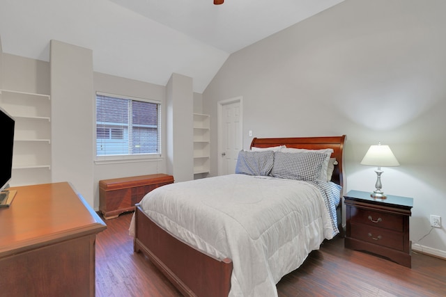 bedroom featuring baseboards, vaulted ceiling, and wood finished floors