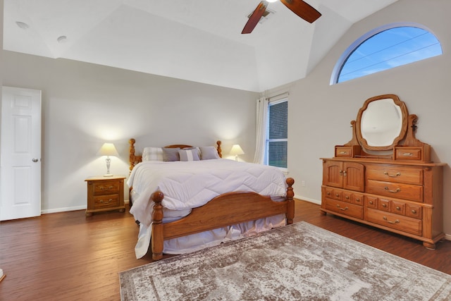 bedroom with ceiling fan, baseboards, vaulted ceiling, and wood finished floors