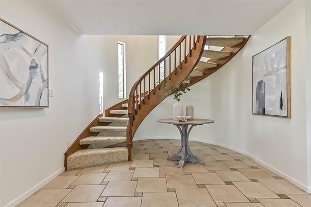 307 Crestwood Dr, El Lago, TX 77586 - stairway with tile patterned floors and baseboards