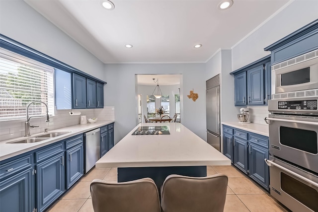 307 Crestwood Dr, El Lago, TX 77586 - kitchen featuring a sink, built in appliances, blue cabinets, a center island, and decorative backsplash