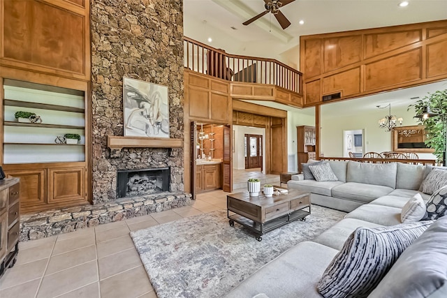 307 Crestwood Dr, El Lago, TX 77586 - living room featuring a stone fireplace, built in features, light tile patterned floors, ceiling fan, and recessed lighting
