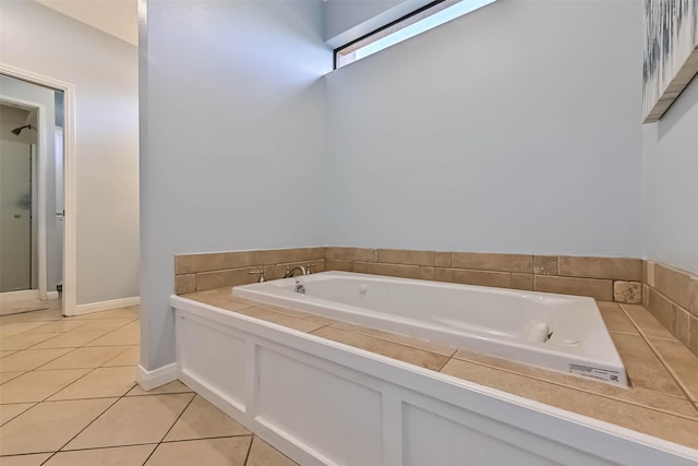 307 Crestwood Dr, El Lago, TX 77586 - bathroom featuring tile patterned floors, baseboards, a garden tub, and a shower stall
