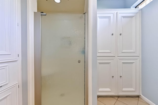 307 Crestwood Dr, El Lago, TX 77586 - bathroom featuring tile patterned floors, a stall shower, and baseboards