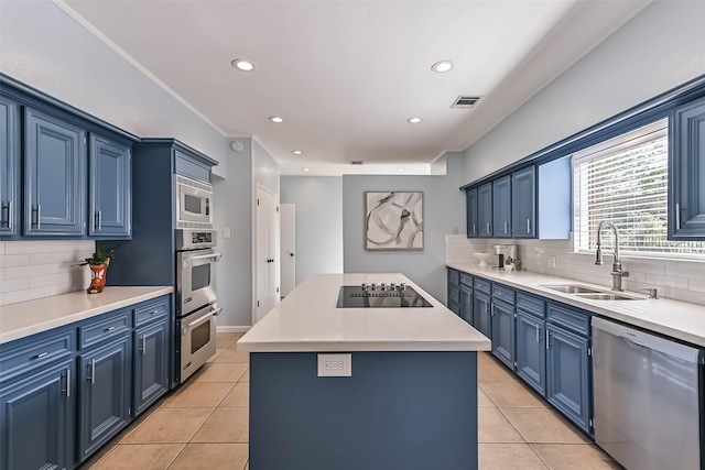 307 Crestwood Dr, El Lago, TX 77586 - kitchen featuring blue cabinets, a sink, stainless steel appliances, and light tile patterned floors