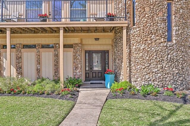 307 Crestwood Dr, El Lago, TX 77586 - doorway to property with stone siding and a balcony