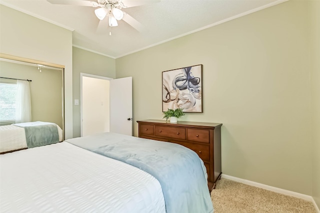 307 Crestwood Dr, El Lago, TX 77586 - bedroom with crown molding, light colored carpet, baseboards, a ceiling fan, and a closet