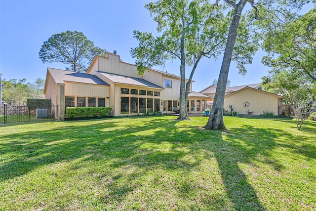 307 Crestwood Dr, El Lago, TX 77586 - rear view of property featuring fence, central AC unit, a shingled roof, a yard, and a chimney