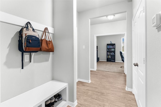 mudroom featuring baseboards and light wood-style floors