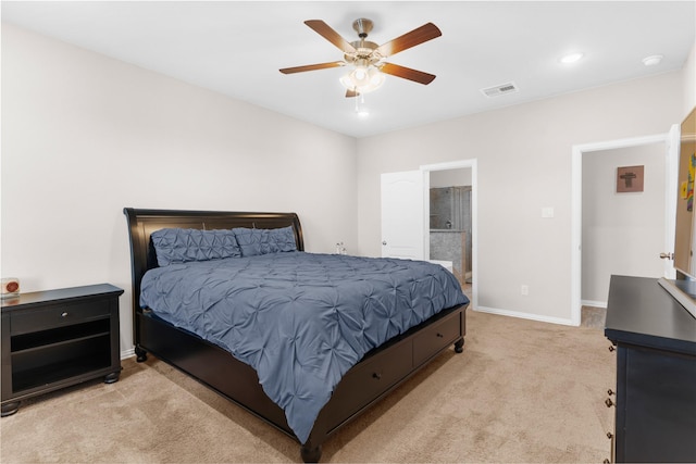 bedroom with light colored carpet, baseboards, visible vents, a ceiling fan, and ensuite bathroom