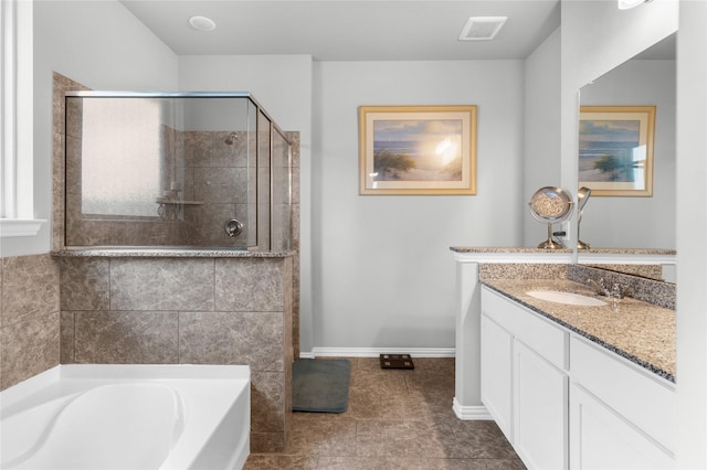 bathroom featuring a bath, visible vents, baseboards, vanity, and a stall shower