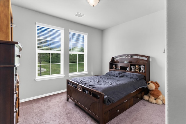 bedroom featuring baseboards, carpet floors, and visible vents
