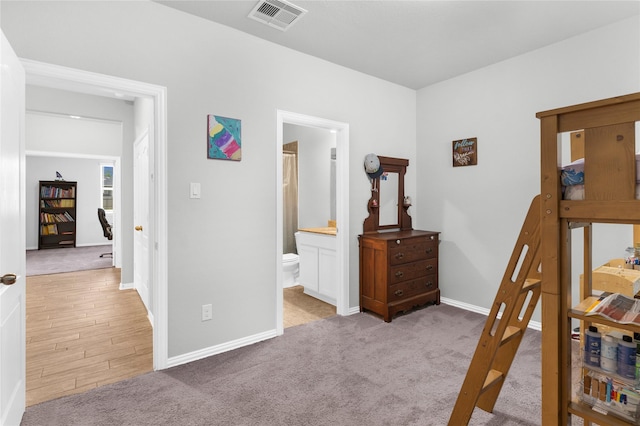 carpeted bedroom with baseboards and visible vents