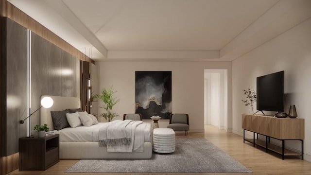 bedroom with light wood-type flooring and a raised ceiling