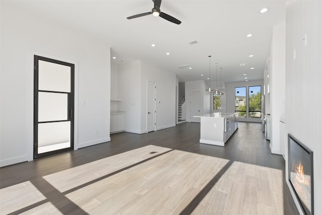 12838 Verdi Dr, Houston, TX 77024 - living area featuring visible vents, stairway, recessed lighting, a ceiling fan, and dark wood-type flooring