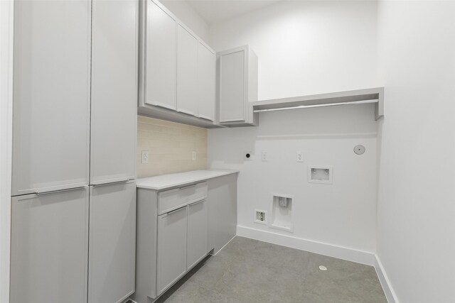 12838 Verdi Dr, Houston, TX 77024 - clothes washing area featuring hookup for a gas dryer, hookup for a washing machine, baseboards, electric dryer hookup, and cabinet space