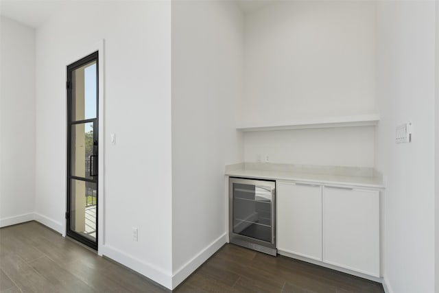 12838 Verdi Dr, Houston, TX 77024 - bar featuring baseboards, a dry bar, dark wood-style flooring, and wine cooler