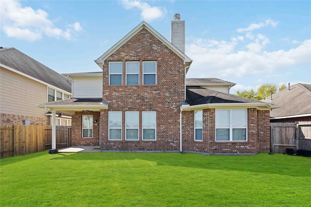 6226 Oxford Lake Dr, Rosenberg, TX 77471 - back of house with a fenced backyard, a yard, and brick siding