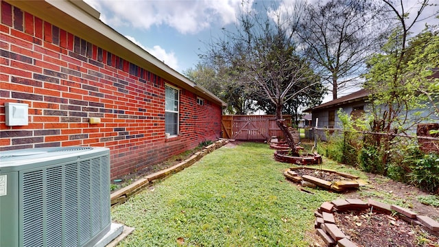 view of yard with central air condition unit and fence private yard