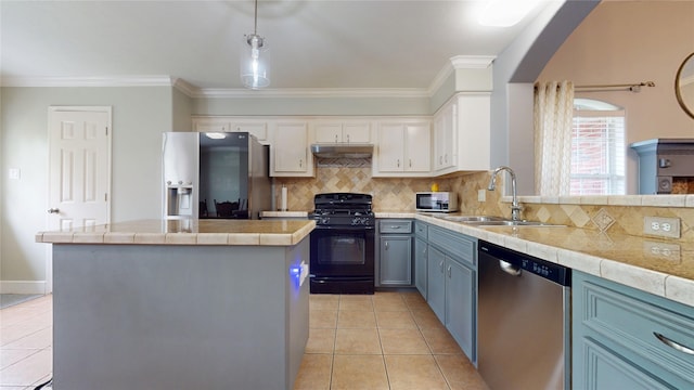 kitchen with crown molding, appliances with stainless steel finishes, under cabinet range hood, a sink, and light tile patterned floors