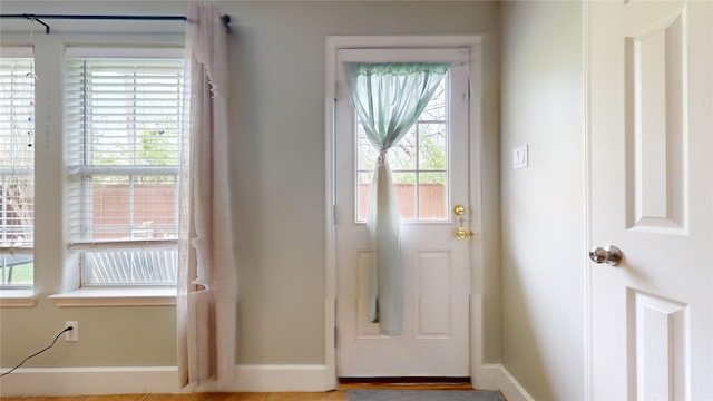 doorway to outside with baseboards