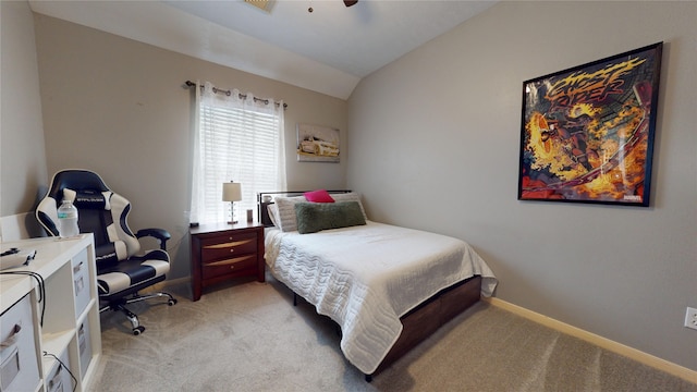 bedroom with a ceiling fan, light carpet, baseboards, and vaulted ceiling