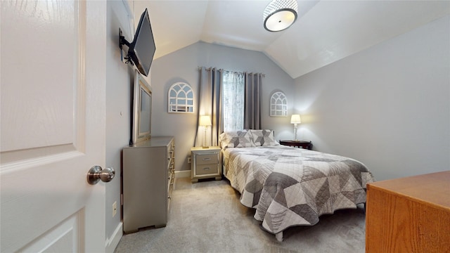 bedroom with light carpet, baseboards, and lofted ceiling
