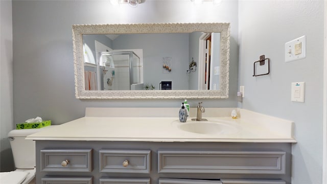 bathroom with a shower stall and vanity