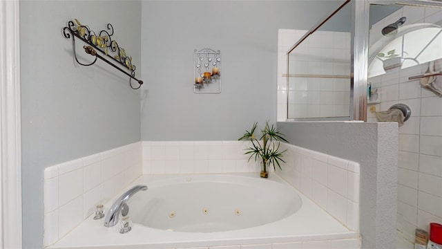 bathroom featuring a tub with jets and tiled shower