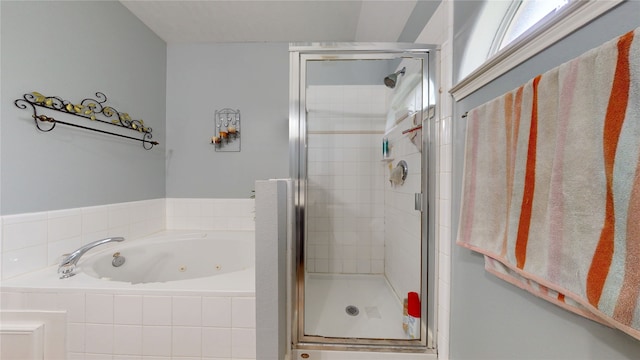 bathroom with a whirlpool tub and a shower stall