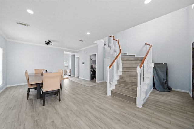 13619 Bonilla Ln, Houston, TX 77083 - dining space with light wood-style floors, crown molding, stairway, and visible vents