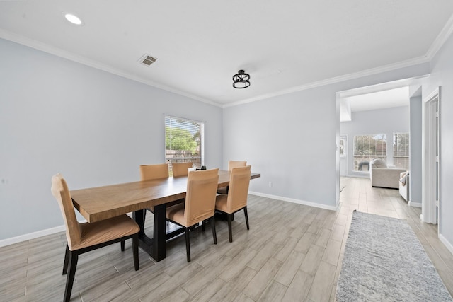 13619 Bonilla Ln, Houston, TX 77083 - dining area with crown molding, light wood-type flooring, recessed lighting, baseboards, and visible vents