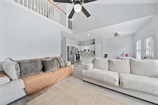 13619 Bonilla Ln, Houston, TX 77083 - living room featuring a high ceiling, light wood-style floors, recessed lighting, and a ceiling fan