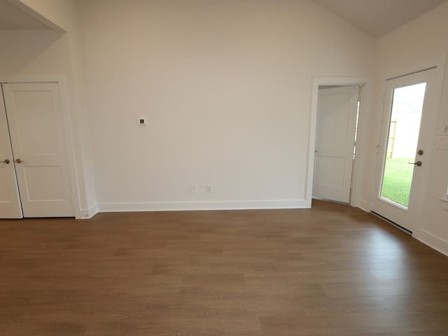 16208 Mcdonald County Ct, Montgomery, TX 77316 - empty room with wood finished floors, vaulted ceiling, and baseboards