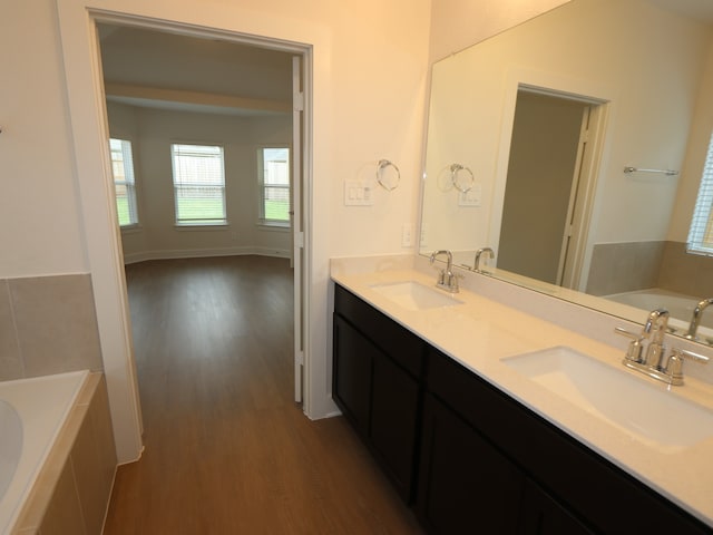 16208 Mcdonald County Ct, Montgomery, TX 77316 - full bathroom with wood finished floors, a bath, and double vanity