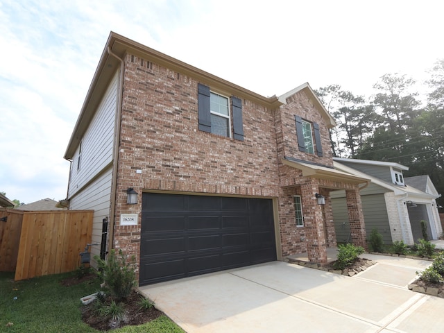 16208 Mcdonald County Ct, Montgomery, TX 77316 - view of front of property featuring a garage, brick siding, and concrete driveway