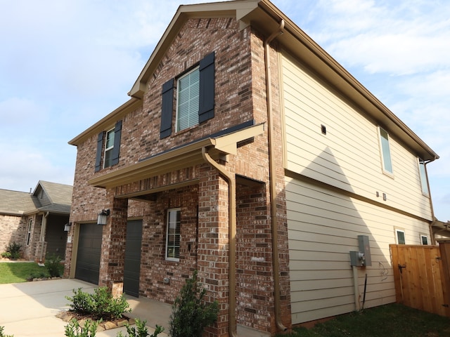 16208 Mcdonald County Ct, Montgomery, TX 77316 - view of home's exterior with an attached garage, brick siding, and concrete driveway
