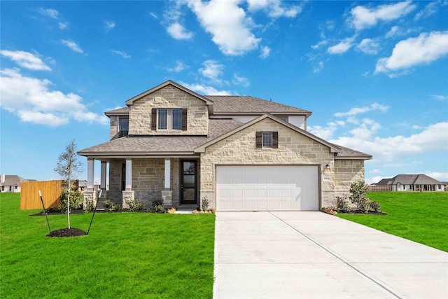 view of front of property featuring a front yard, stone siding, concrete driveway, fence, and a shingled roof