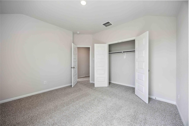 unfurnished bedroom featuring baseboards, carpet flooring, visible vents, and a closet