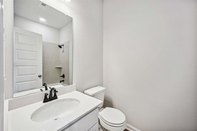 bathroom featuring baseboards, visible vents, toilet, and vanity