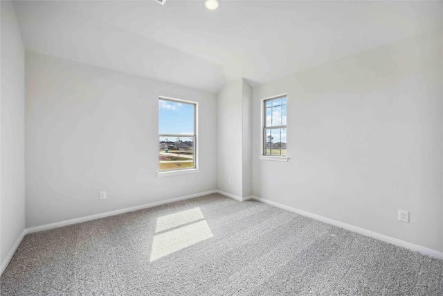 carpeted spare room with baseboards