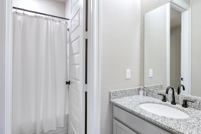 17473 Chestnut Cove Dr, Conroe, TX 77302 - bathroom with vanity, a textured wall, and shower / tub combo with curtain