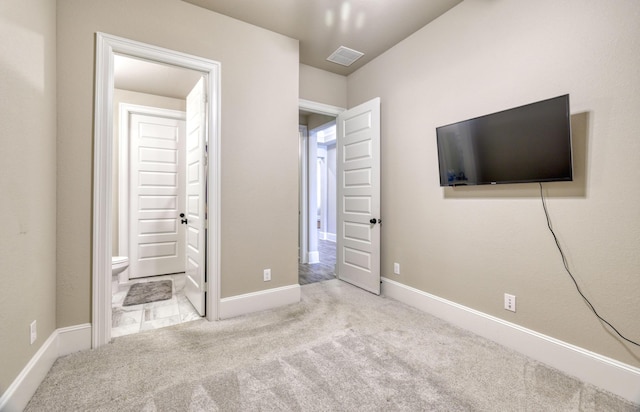 17473 Chestnut Cove Dr, Conroe, TX 77302 - unfurnished bedroom with carpet, ensuite bathroom, and baseboards