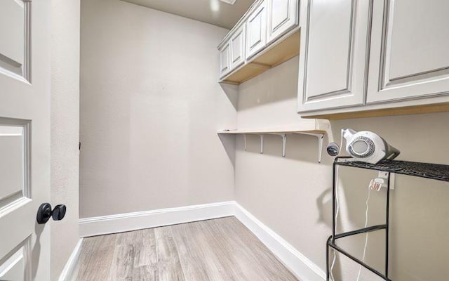 17473 Chestnut Cove Dr, Conroe, TX 77302 - laundry room featuring baseboards and wood finished floors