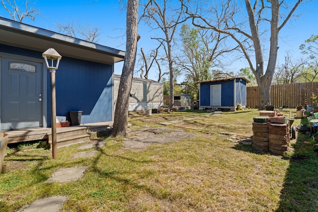 413 Mulcahy St, Rosenberg, TX 77471 - view of yard featuring an outbuilding, fence, and a shed