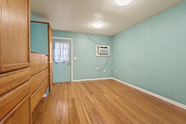 413 Mulcahy St, Rosenberg, TX 77471 - unfurnished room featuring a wall mounted AC, baseboards, and light wood finished floors