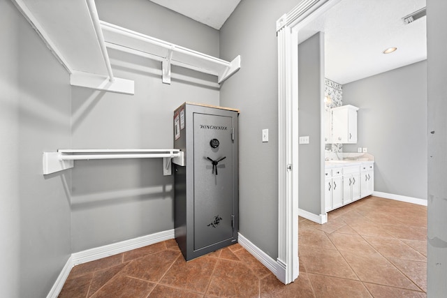 interior space featuring baseboards, visible vents, and tile patterned floors