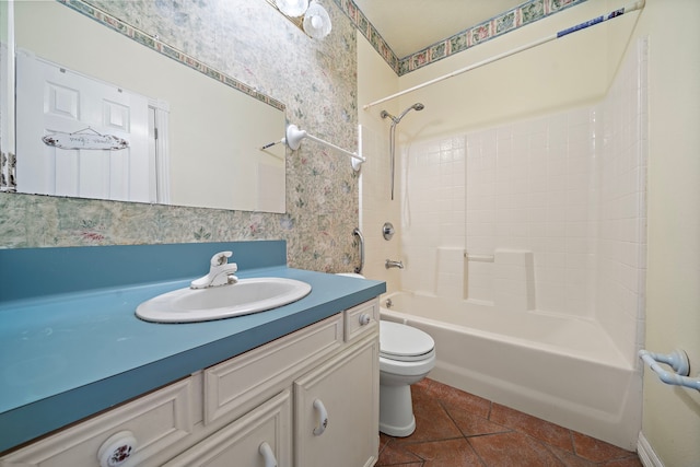 bathroom with tile patterned flooring, vanity, toilet, wallpapered walls, and shower / tub combination